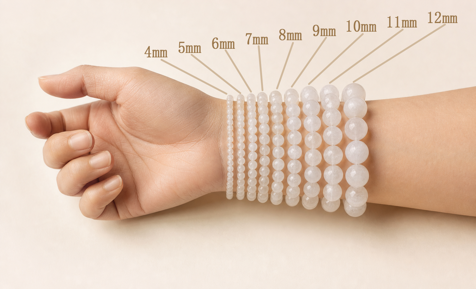 One wrist wearing pale translucent round stone bracelets from 4 to 12 millimetres