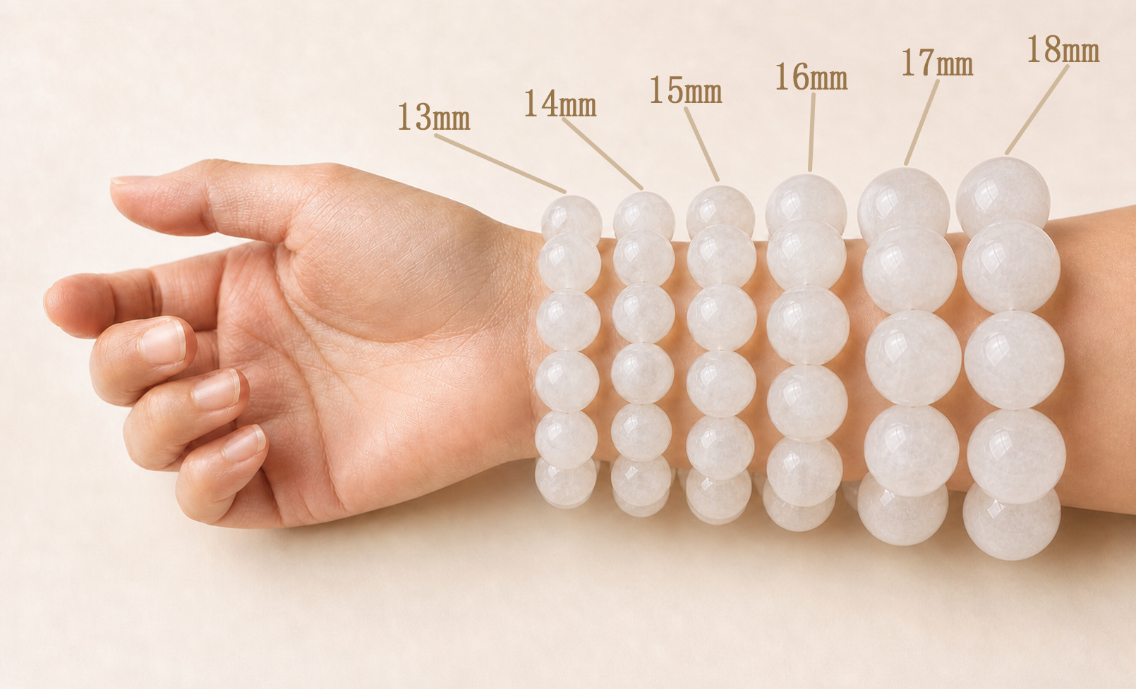 One wrist wearing pale translucent round stone bracelets from 13 to 18 millimetres